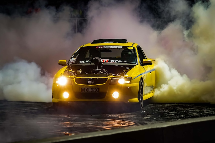 A yellow Commodore does a burnout
