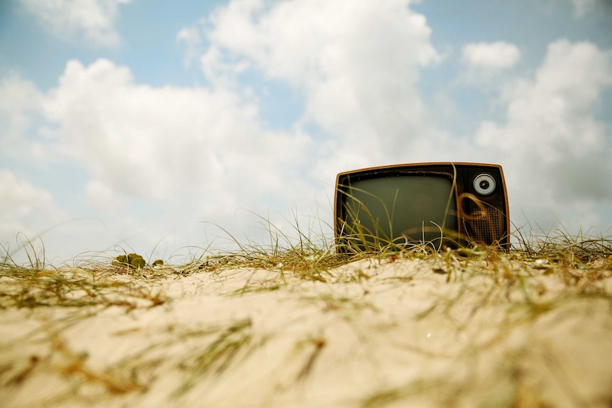 Discarded television in the sand to depict the reclamation of wasted time.