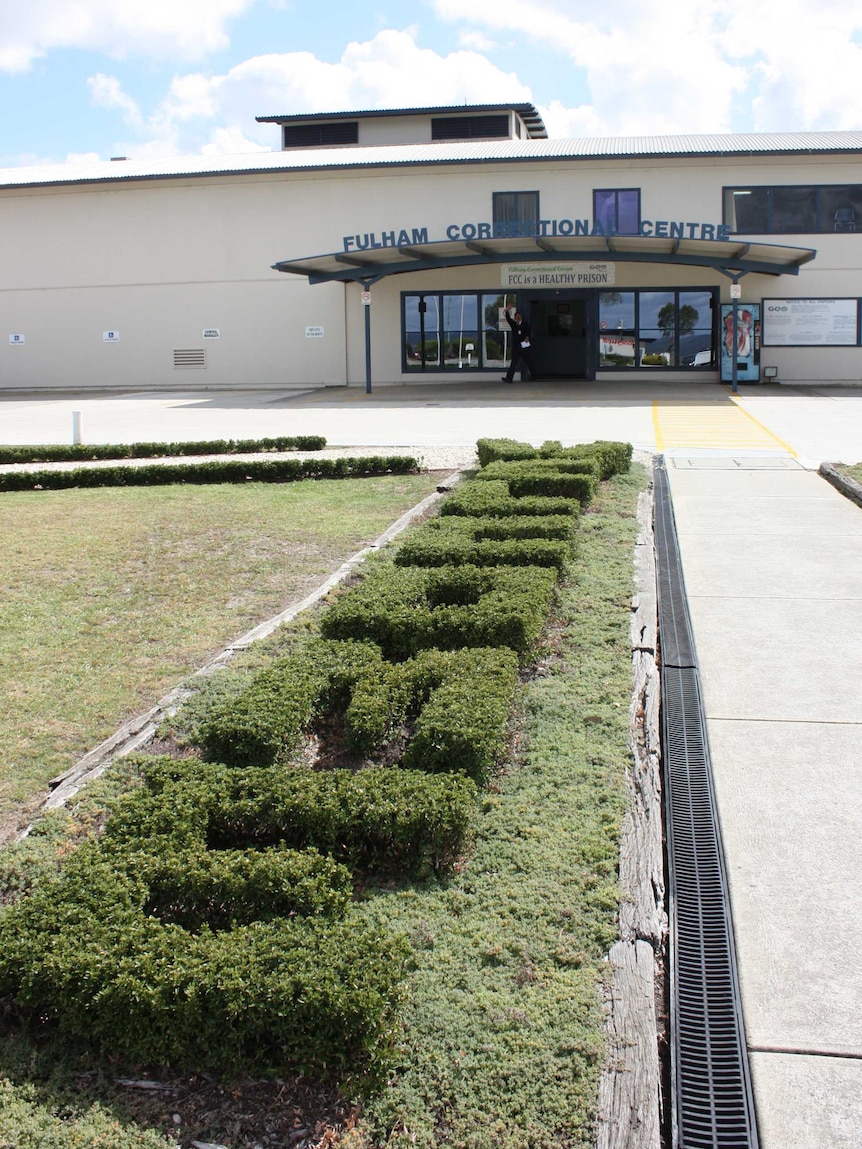 Green hedges spell "welcome" at the entrance of Fulham Correctional Centre.