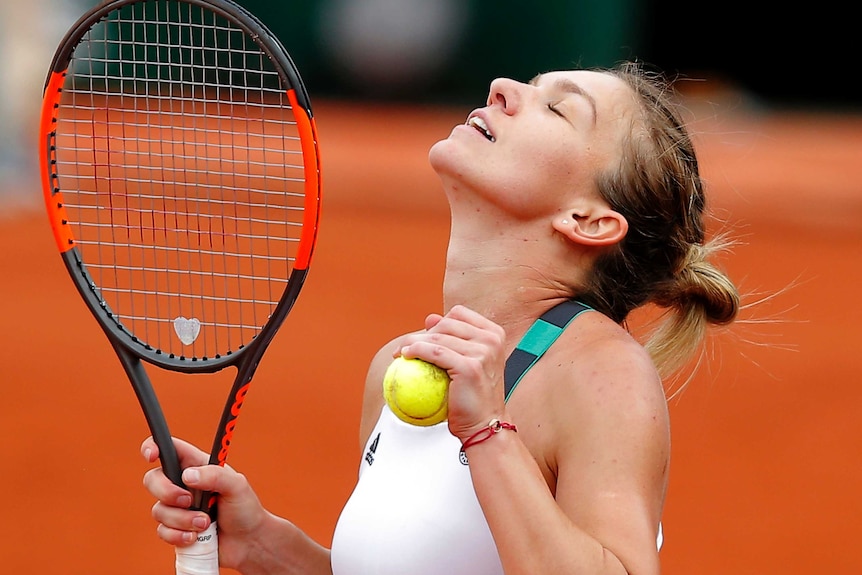 Simona Halep shows her relief after defeating Karolina Pliskova in three sets.