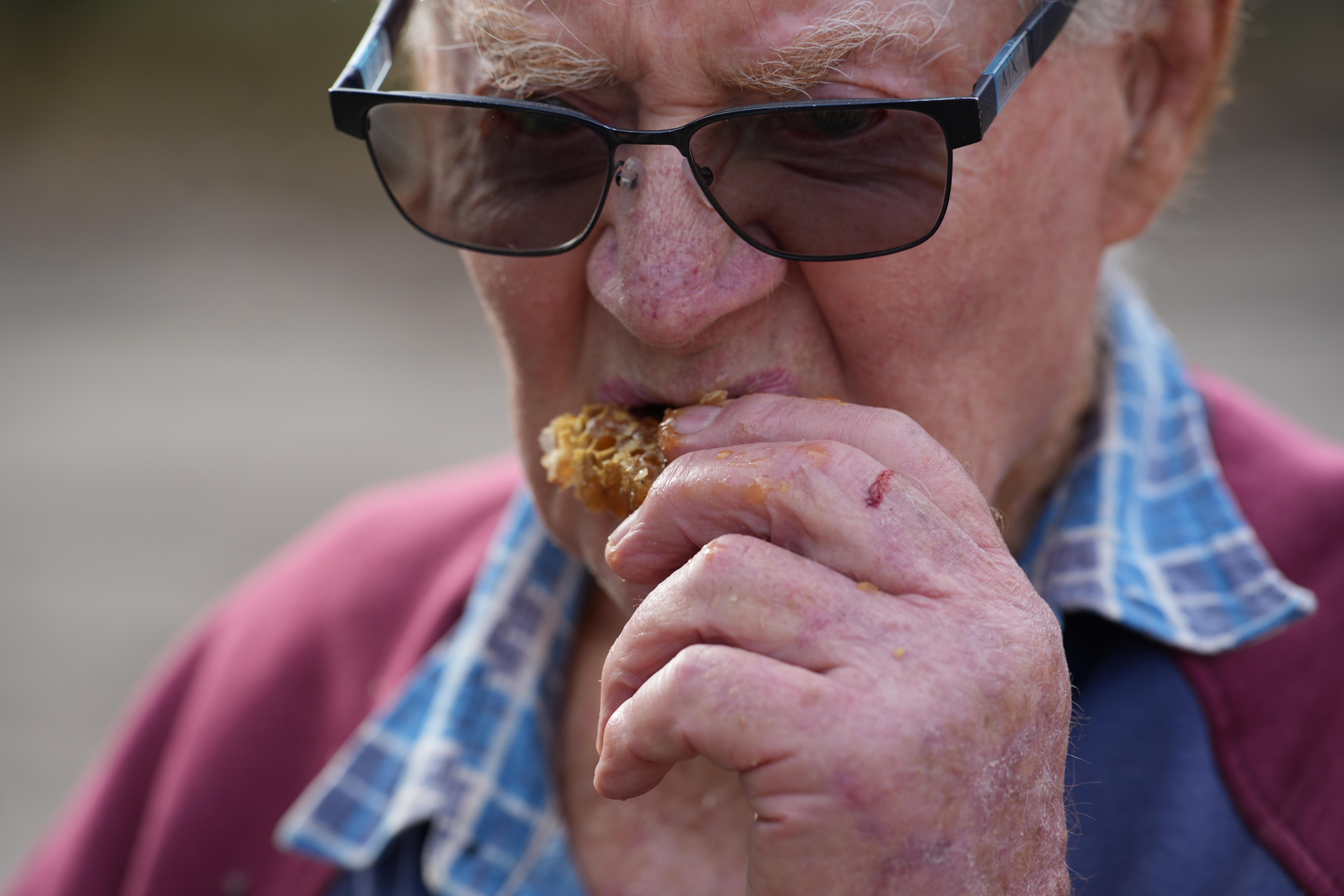 a man eating honeycombe