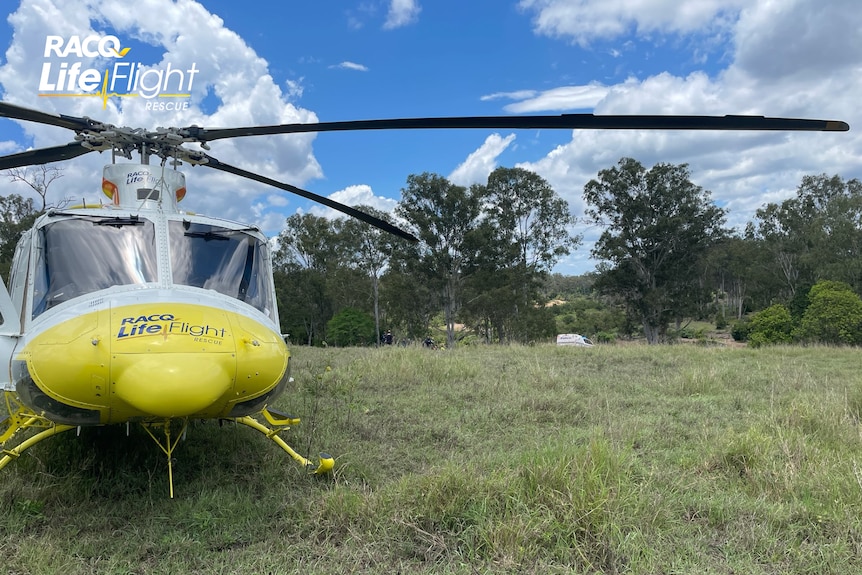 An image of a yellow RACQ LifeFlight Rescue helicopter 