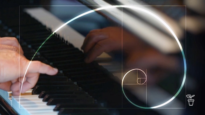 Hands on piano keyboard with graphic swirl over the top of the image