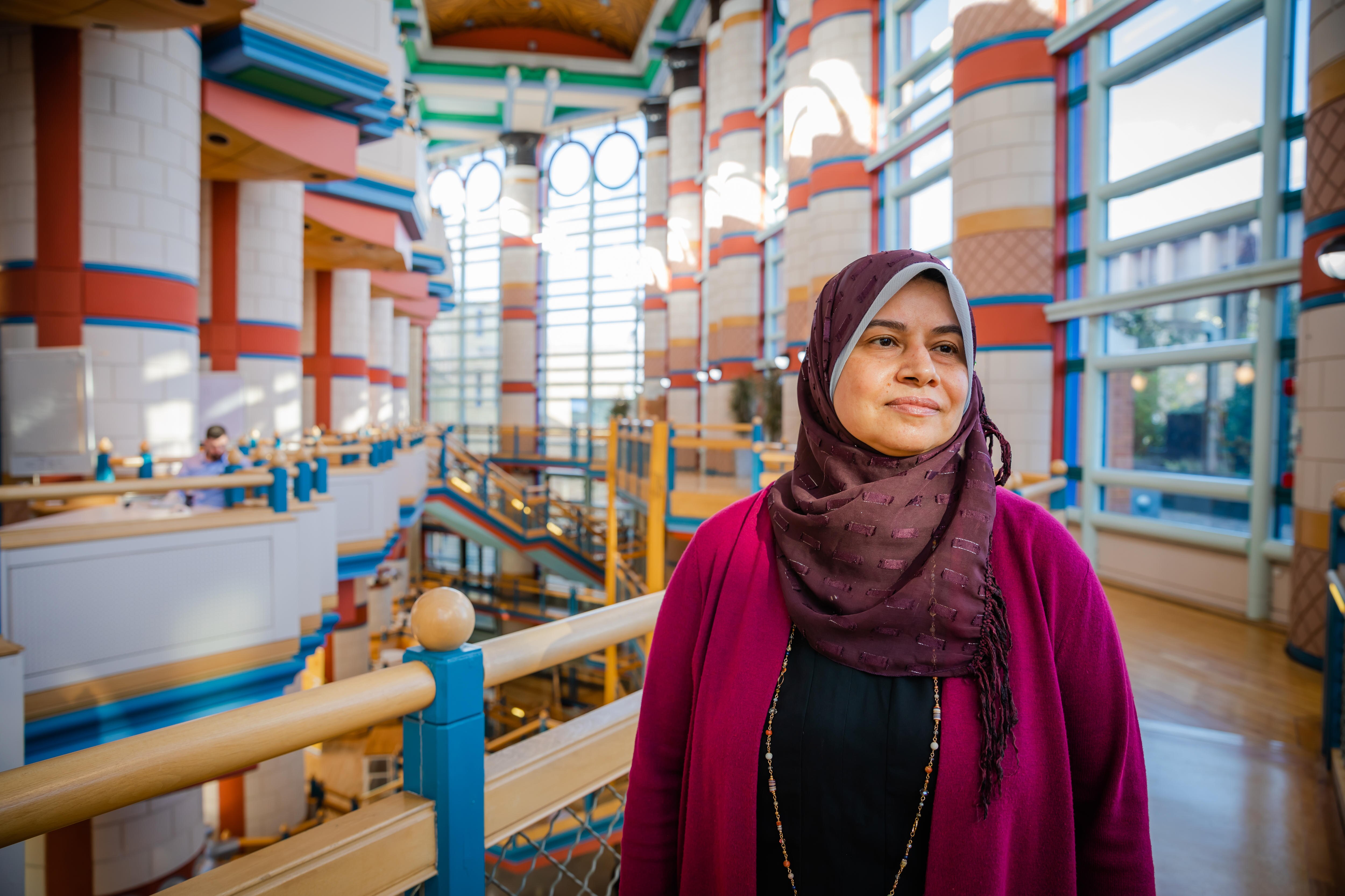 An Arabic woman wearing a purple headscarf.  