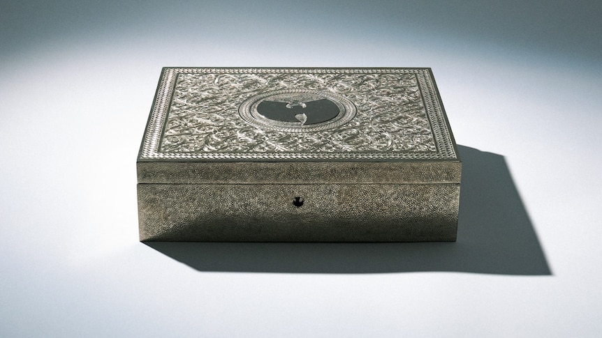 A silver box with an intricate etching.