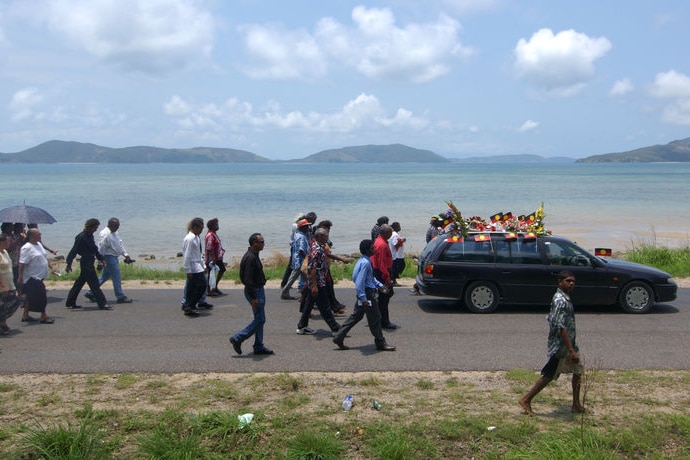 Mourners follow hearse carrying Mulrunji