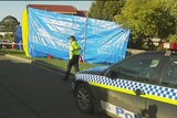 Police outside the unit in  Ravenswood, Tasmania, where two bodies were found.