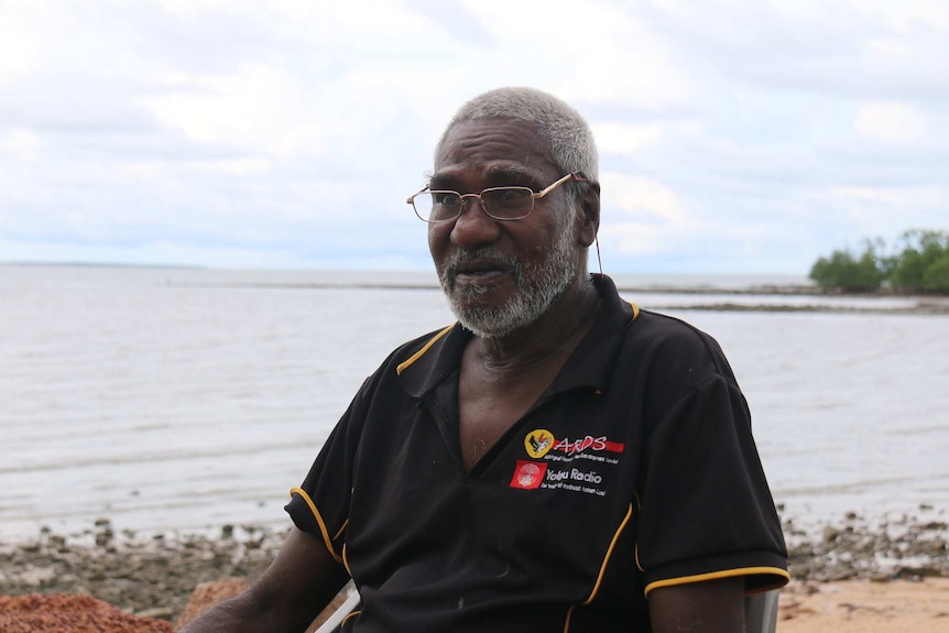 Maningrida George 'Gappala' Pascoe sits at the beach, reflecting on his own childhood as a victim of the stolen generation.