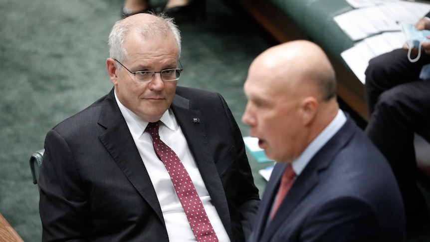 Scott Morrison watches Peter Dutton speaking in Question Time