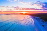 A drone photo of an orange sunset over the beach at Esperance.