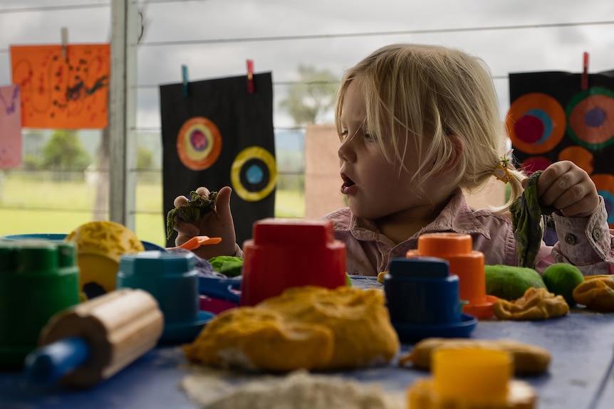 Photo of a child playing with craft.