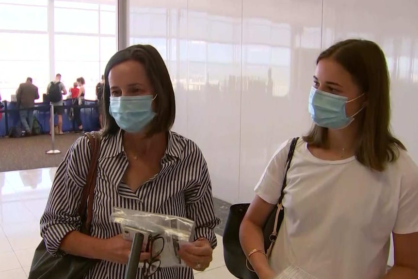 Two women being interviewed at Adelaide Airport