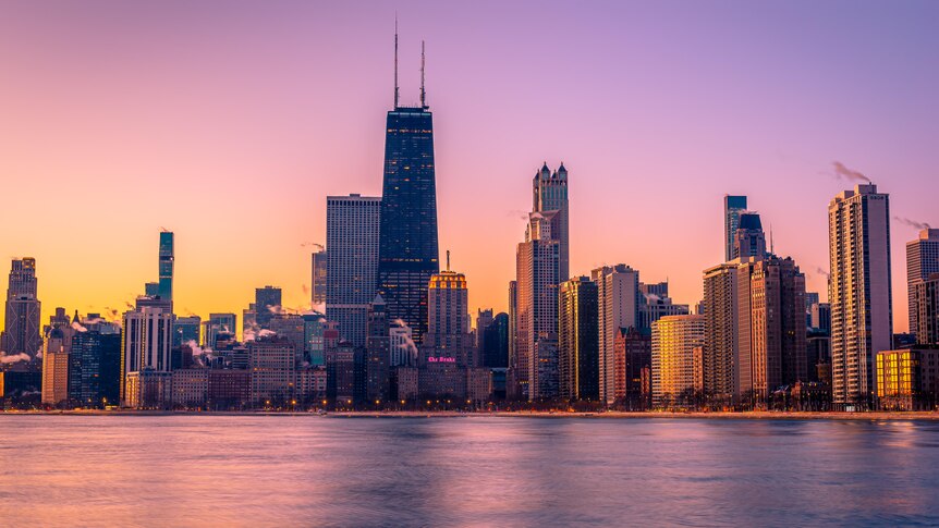 a view of the Chicago skyline at sunrise. 