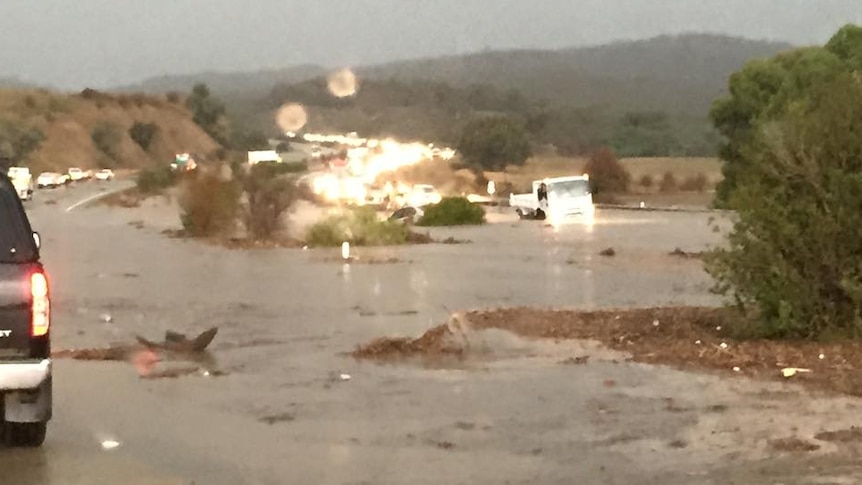 A truck stranded in the middle of flash flood waters on the Federal Highway.