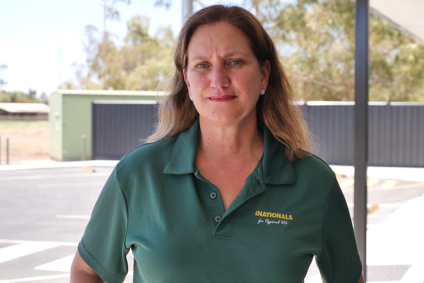 A mid-shot of the Nationals MP for North-West Central Merome Beard standing outside posing for a photo in a green shirt.