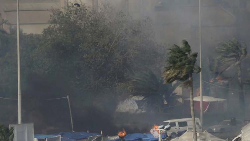 Smoke rises from burning tents at Pearl Square