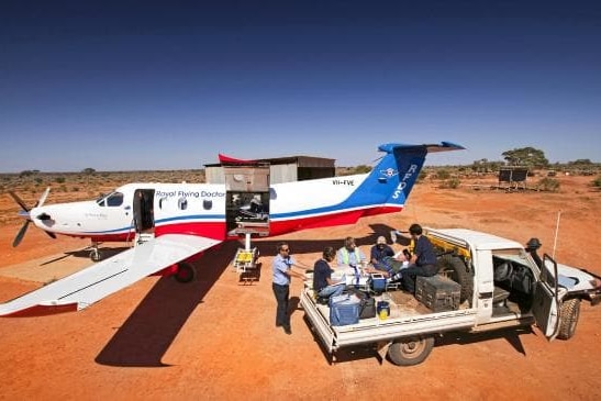 Plane and ute on red dirt.