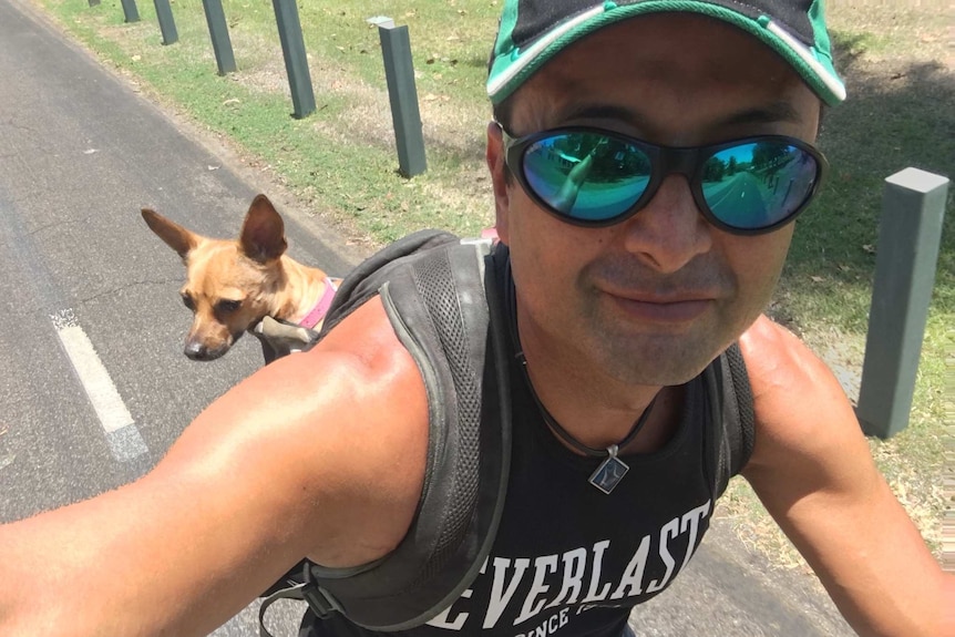 Mark rides a bike with his dog Meer, for a story on finding care for pets while travelling.