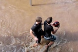 Two men relax with a game of basketball in the floods at Wagga Wagga.