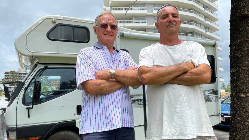Two Rainbow Bay residents standing in front of a camper van.