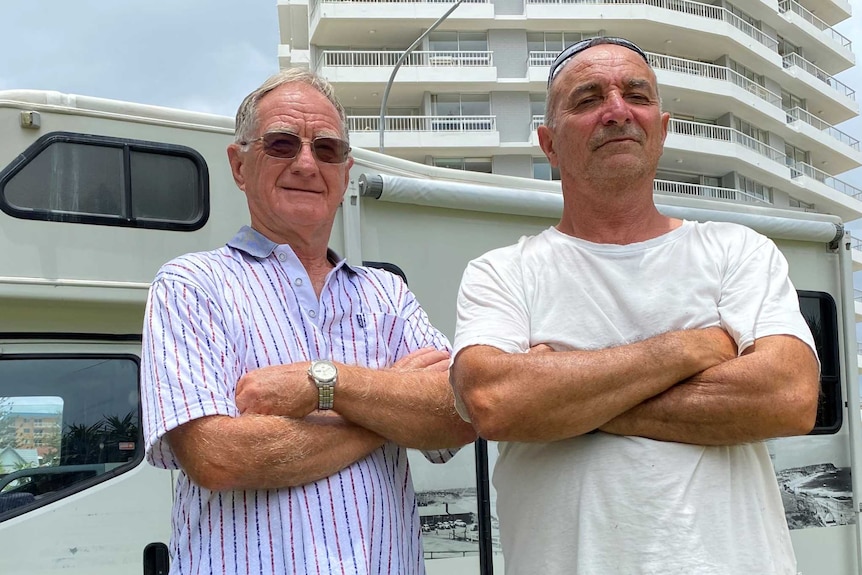 Rainbow Bay residents Bernie McGuiness (left) and Mena Tsikles standing in front of a camper van.