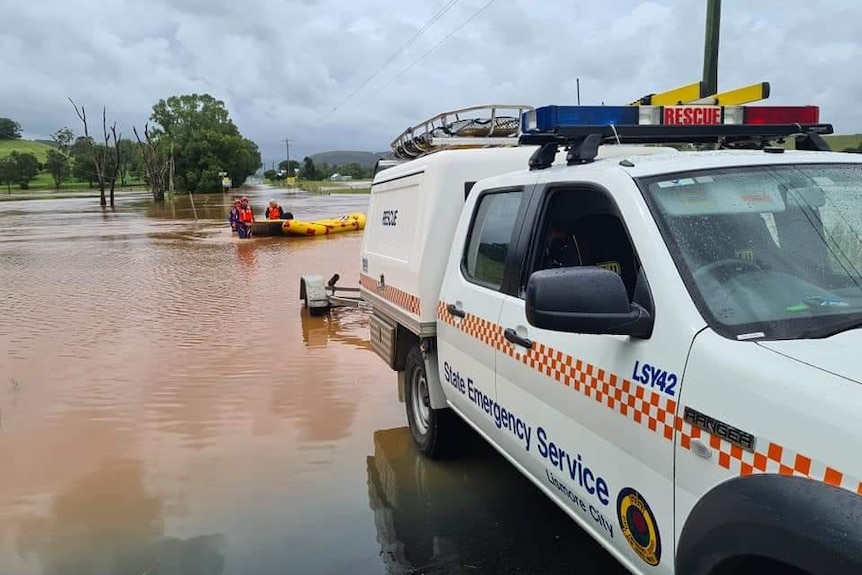 An SES vehicle and SES boat near floodwater