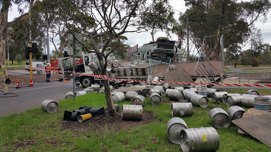 Beer kegs strewn across Elliot Avenue in Parkville after a truck collided with a tram.