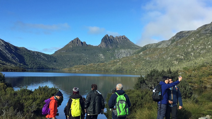 Tourists take in the view at Cradle Mountain