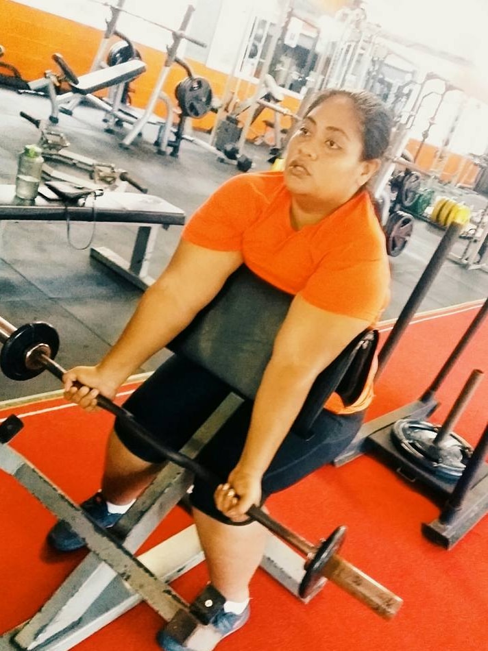 Betty Pinati lifts weights at the gym.