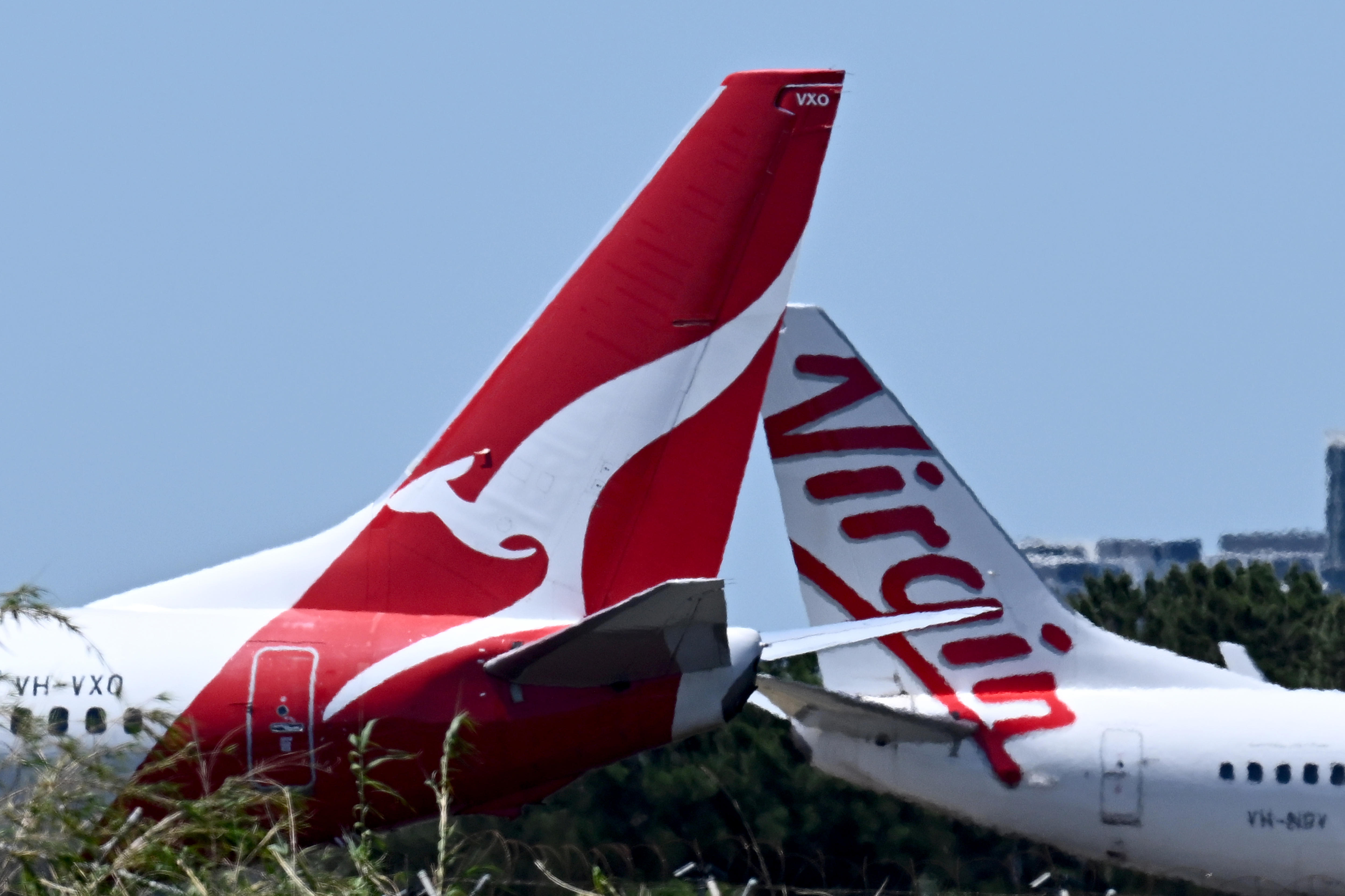  virgin and qantas planes next to each other