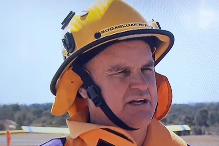 Rural firefighter James Massey wearing a helmet and firefighting jacket.