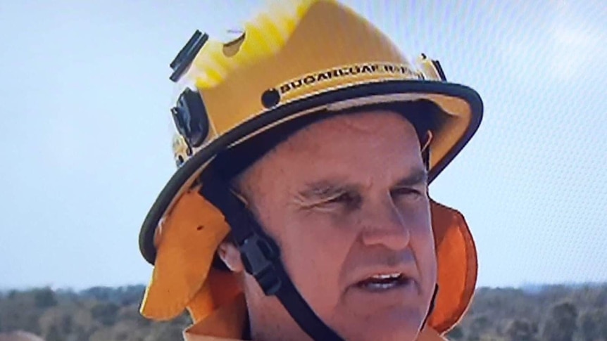 Rural firefighter James Massey wearing a helmet and firefighting jacket.