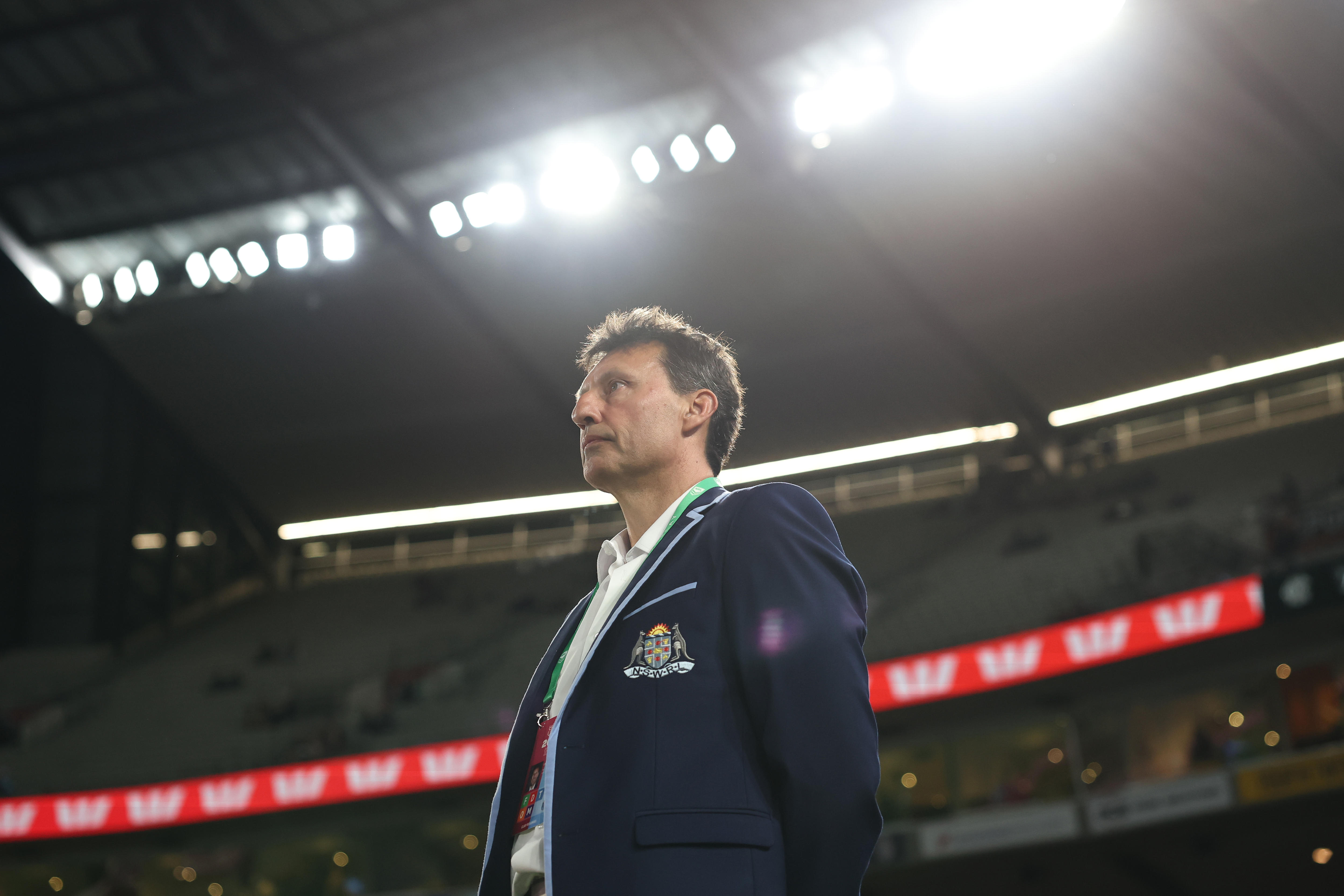 NSW Blues coach Laurie Daley stands under the lights of the MCG.