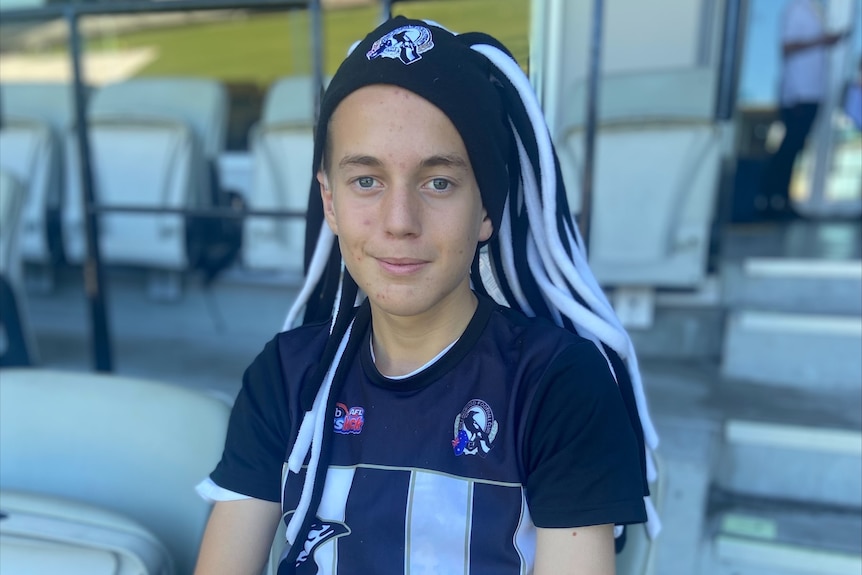 Calvin Black sits at the MCG wearing a hat with black and white colours