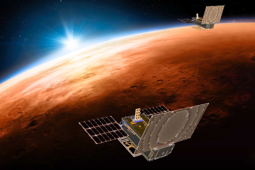 An artist's impression of two small satellites flying over Mars.