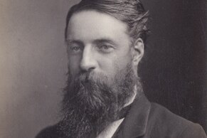 A  black and white photograph of a man in an old fashioned suit and long beard
