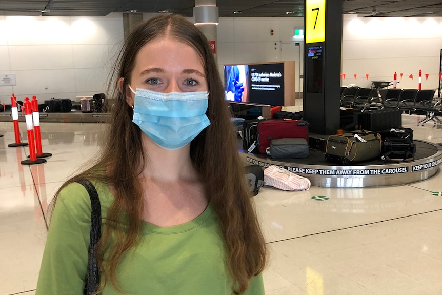 Abby Hayes wearing a mask at Brisbane airport.