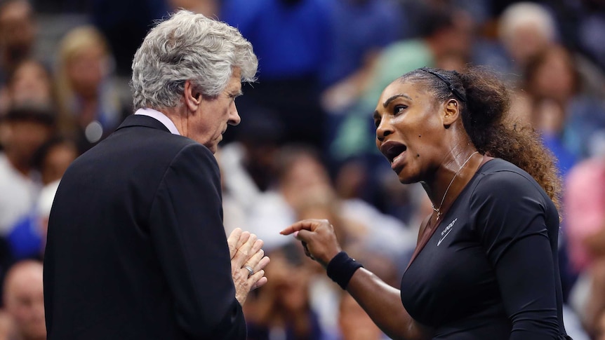 US Open director Brian Earley clasps his hands together as Serena Williams yells at him.