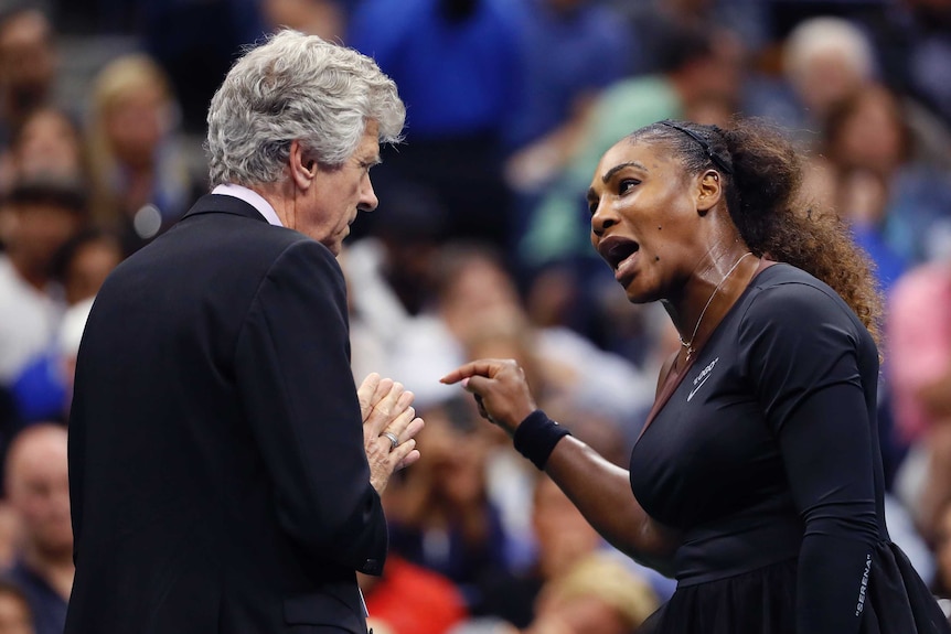 US Open director Brian Earley clasps his hands together as Serena Williams yells at him.