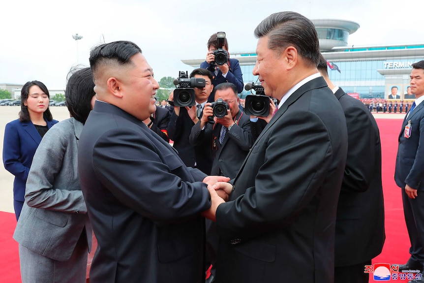 North Korean leader Kim Jong-un and Chinese President Xi Jinping bid farewell at Pyongyang International Airport in Pyongyang.