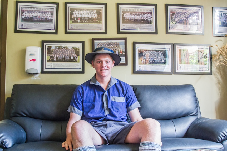 School boy sitting on a couch