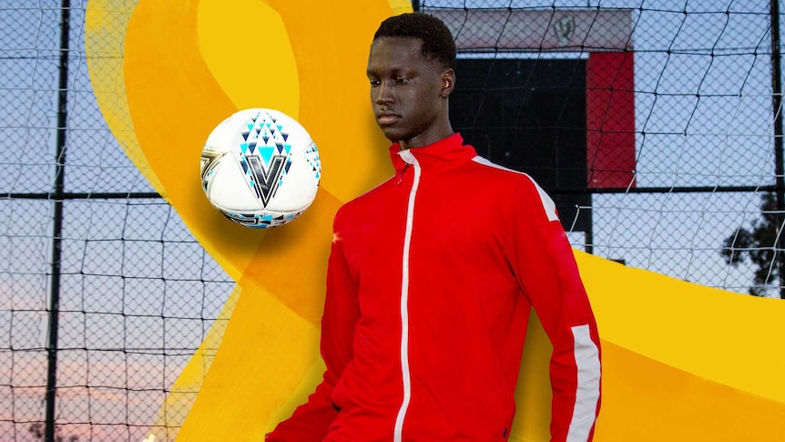 A Teenage boy in soccer training gear juggles a soccer ball in front of soccer goal net.