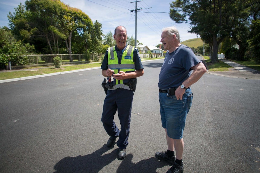 Policeman Paul Delaney shares a laugh with a neighbour in the middle of his street.