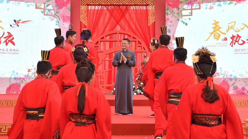 Alibaba founder Jack Ma, surrounded by couples wearing red at the annual Ali Day group wedding.