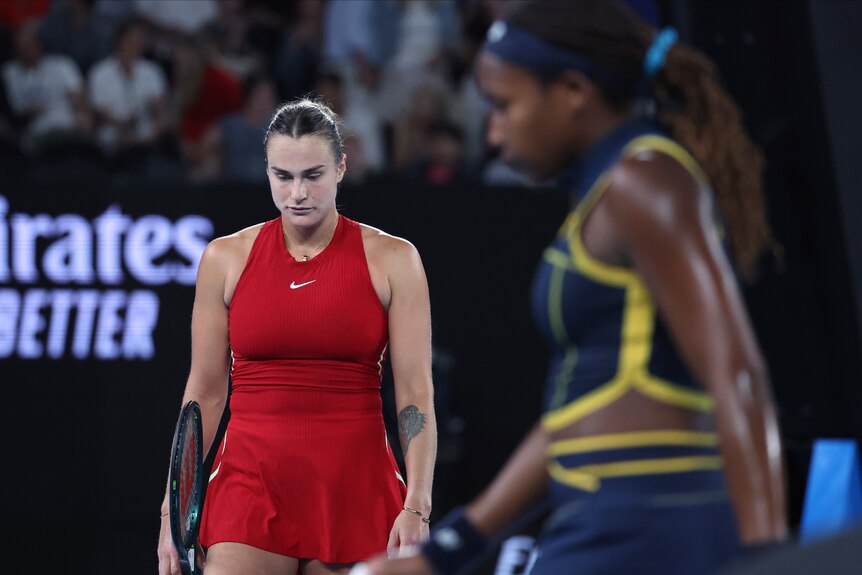 Aryna Sabalenka and Coco Gauff walk on court during their Australian Open semifinal.