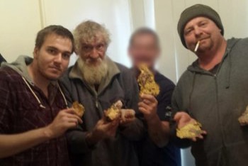 Four men pose with stolen gold.