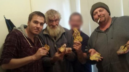 Four men pose with stolen gold.