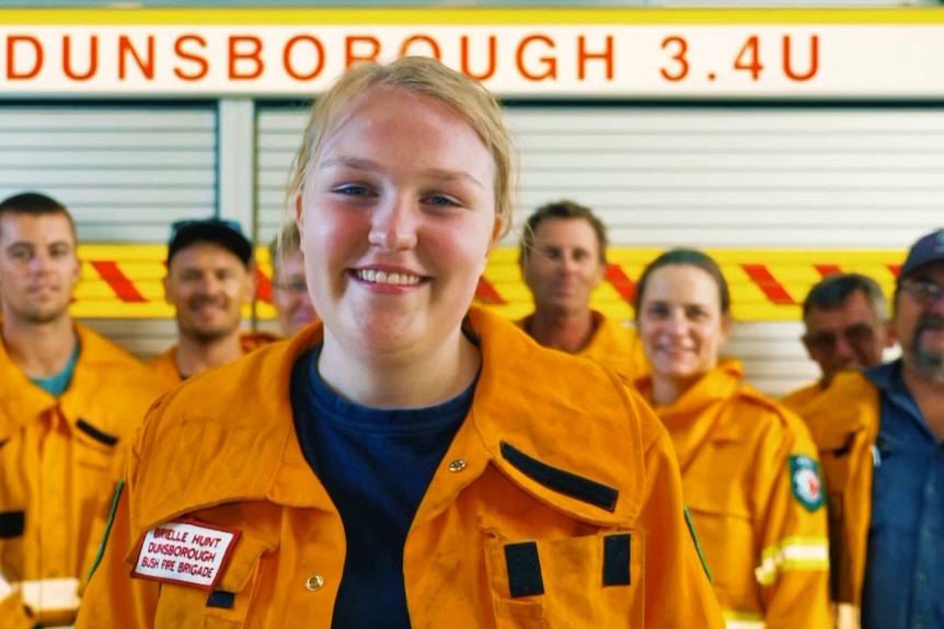 Heywire winner Brielle is front and centre with the rest of the Dunsborough fire crew behind her and a truck behind them.