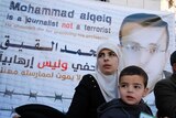 The wife of Palestinian imprisoned journalist Mohammed al-Qiq, Fayha Shalash, with her son Islam