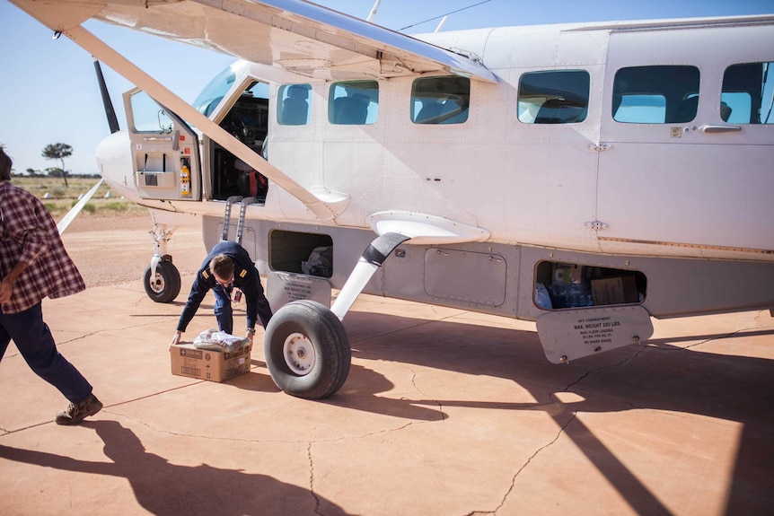 Chartair pilot Harvey Salameh unloads a plane in Tjuntjuntjara, remote WA.